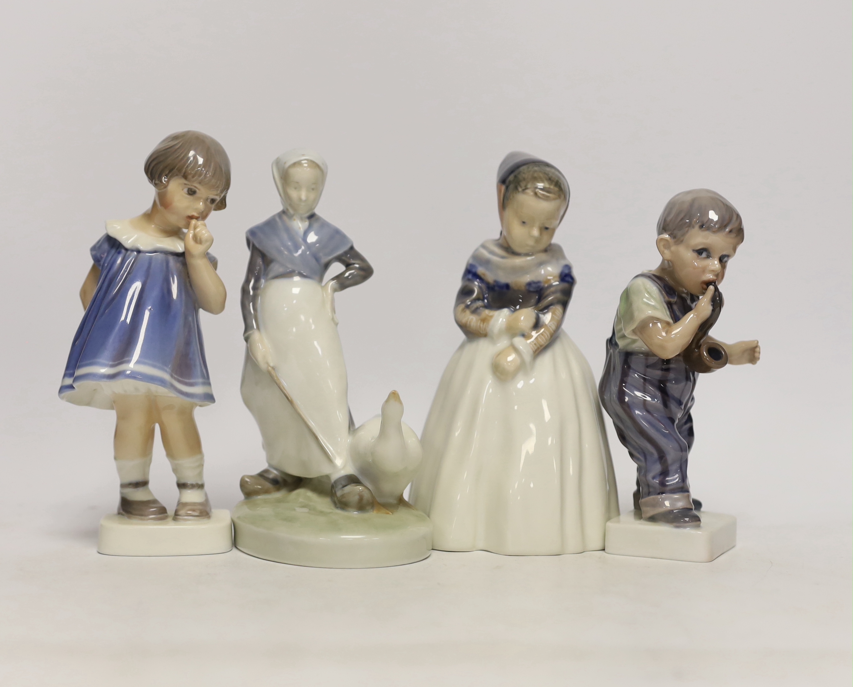 Four Royal Copenhagen figures and figurines of children, largest 19cm high